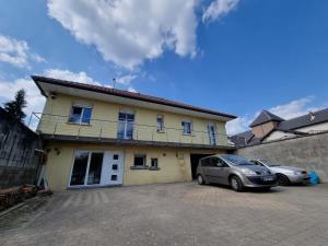 a car parked in a parking lot in front of a house at Appartement "L'orée des trois frontières" in Allondrelle-la-Malmaison