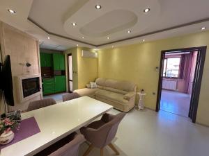 a living room with a table and a couch at Луксозен апартамент in Vratsa +12 photos