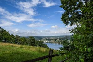 a view of a river from a hill with a fence at One Ski Hill in McHenry