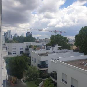 a view of a city skyline with a crane at Studio a Suresnes in Suresnes +4 photos