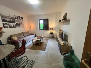 a living room with a couch and a table at Casa Pura in Ampezzo