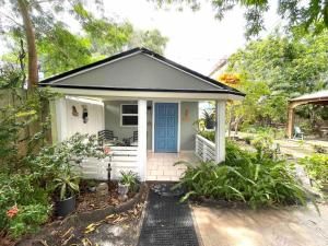 a small white house with a blue door at Independent Studio in Little Havana in Miami