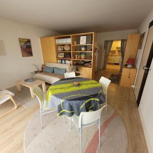 a living room with a table and chairs and a couch at villa deloro in Orbey