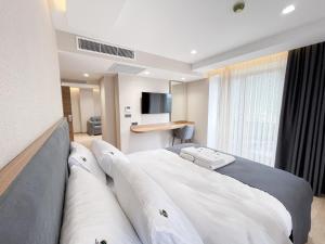 a hotel room with a bed and a television at Ladur Resort Otel in Trabzon