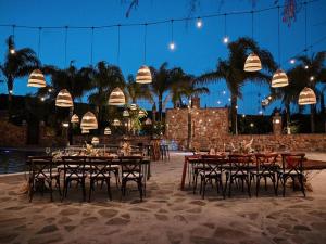 a group of tables and chairs in a courtyard at Surya Hotel in Valle de Guadalupe +17 photos