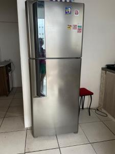 a stainless steel refrigerator in a kitchen at Quarto rosa em frente moradia unicamp in Campinas