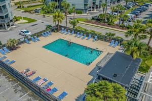 vista sulla piscina con sedie a sdraio e sidx sidx. di Sea Cabin Ocean View Unit 225 a Myrtle Beach