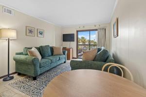 a living room with two couches and a table at Seafarer Oceanview Unit 107 in Myrtle Beach