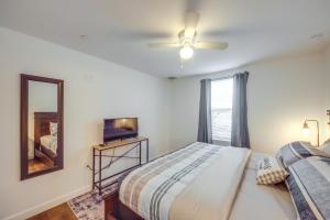 a bedroom with a bed and a mirror and a television at LaBelle Apartment, Close to Parks! in La Belle