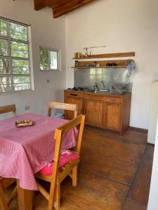 a kitchen with a table and a sink and a stove at Linda casa en Tepoztlan centro 2 in Tepoztlán +9 photos