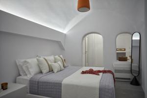 a white bedroom with a bed with white walls at 1949 Cave Residence in Pirgos +22 photos