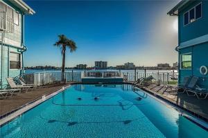 a swimming pool with a view of the water at The Seashell Suite with Private Balcony and Walk to Beach in Clearwater Beach