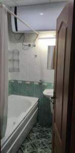 a bathroom with a bath tub and a sink at Panoramic Apartment 301 in Eagle Rock Complex in Beli Iskar +48 photos