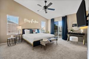a bedroom with a bed and a desk in it at Putt Putt Hot Tub Game Room Pool Cornhole in Chandler +46 photos
