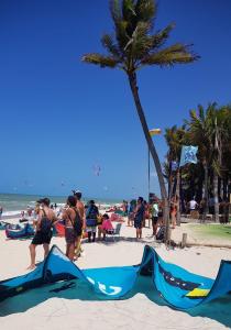 a group of people on the beach with kites at Apartamento kite surfe Cumbuco Tabuba in Caucaia