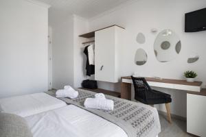 Postel nebo postele na pokoji v ubytování Aurora - Rooms & Suites - Spetses
