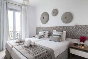 Postel nebo postele na pokoji v ubytování Aurora - Rooms & Suites - Spetses