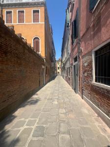 an empty alley between two brick buildings at Venice Secret Garden view in Venice