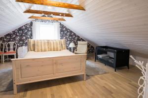 a bedroom with a bed and a fireplace in a attic at Vintage Four katusekorter in Haapsalu