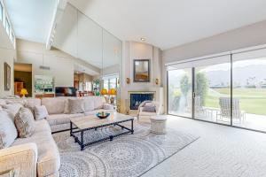 a living room with a couch and a table at Southern Hills Charm Permit# 65256 in La Quinta