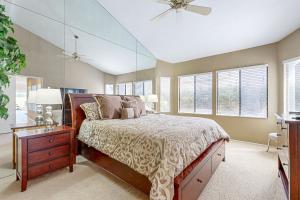 a bedroom with a bed and a dresser and windows at Southern Hills Charm Permit# 65256 in La Quinta +21 photos