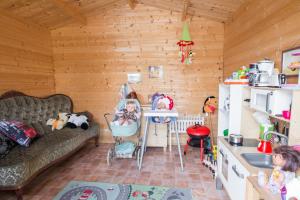 a living room with a couch and two children in a kitchen at Vintage Four terrassiga korter in Haapsalu +21 photos