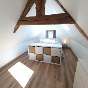 a room with a bed in the attic at Le Cocon Perché - Nid Secret in Longny-au-Perche +10 photos