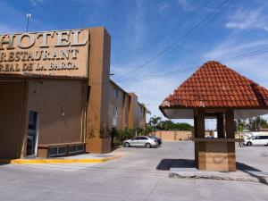 a sign for a hotel in a parking lot at Hotel Real de La Barca in La Barca