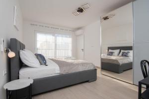 a bedroom with two beds and a mirror at VILLA OCEAN BREEZE with pool in Zaglavice +55 photos