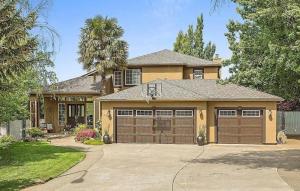 a house with two garage doors in a driveway at Fantastic Bright 4 Bedroom- Deck - Fireplaces in Medford