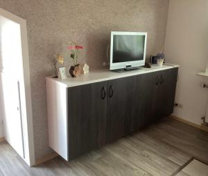 a television on top of a cabinet in a room at Haus der Gemütlichkeit in Konstanz