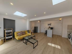 a living room with a yellow couch and a table at Gated 4 Guests House Free Parking in Bristol
