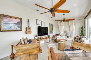a living room filled with furniture and a flat screen tv at Waterfront Key Largo Oasis with Boat Dock and Swim Spa in Key Largo