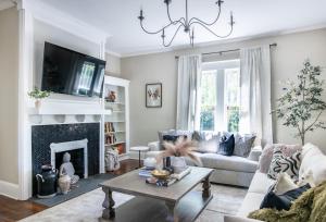 a living room with a couch and a fireplace at Spacious Highland Park Home, Family&pet Friendly in Birmingham