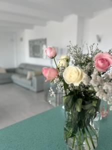 a vase filled with flowers sitting on a table at Casa Mazagón con vistas al mar in Mazagón +93 photos