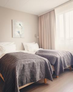 A bed or beds in a room at Hótel Fransiskus Stykkishólmi