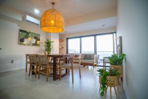 a dining room with a table and chairs and a chandelier at Aloha Mazatlan in Mazatlán