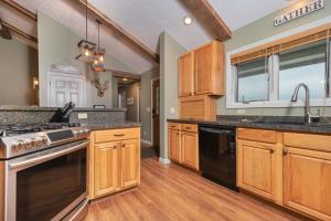 a kitchen with wooden cabinets and black appliances at License to Chill in Swanton