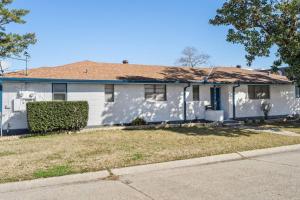 a white house with a brown roof at NOLA (3Bd) hub in Metairie