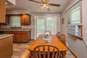 a kitchen with a table with chairs and a ceiling fan at Laurel Ridge in McHenry