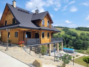 una gran casa de madera con techo negro en Villa Ligęzówka, en Chyrowa