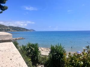 a view of a beach with people in the water at La Casa di Bet in San Lorenzo al Mare +6 photos