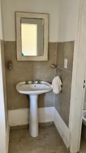a bathroom with a sink and a mirror at La Maga in Santa Rosa de Calamuchita +10 photos