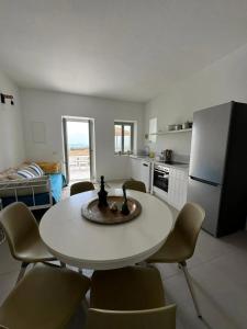 a kitchen with a table and chairs in a room at Comfortable apartment with sea view in Antiparos, 77 m² in Andiparos