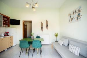 a living room with a couch and a table at Nas Mar & Twins - Aristea in Petrití