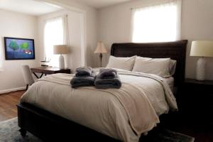 a bedroom with a bed with two towels on it at Charming Classic Cottage 2Br in Durham