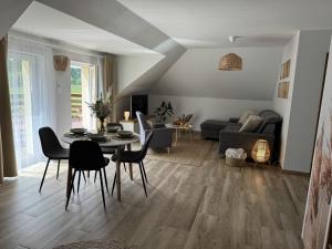 a living room with a table and chairs at Stylowe apartamenty in Charzykowy