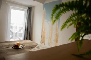 a candle on a table in a room with a window at Stylowe apartamenty in Charzykowy