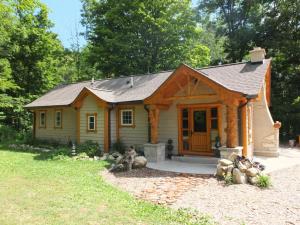 a log cabin with a porch and a door at La Maison Malabar - Gorgeous Luxury Cabin! in South Haven
