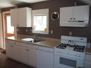 a kitchen with a white stove and a sink at The Cute & Cozy - Upper Apt - Great Location! in Frankfort